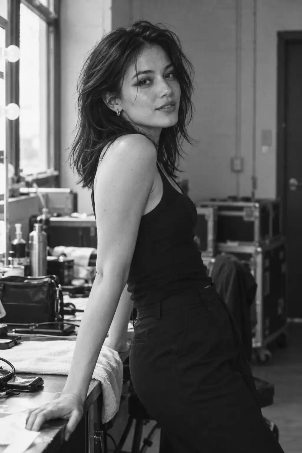 Black-and-white editorial illustration of a female singer backstage